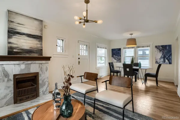 a living room with furniture a fireplace and a flat screen tv
