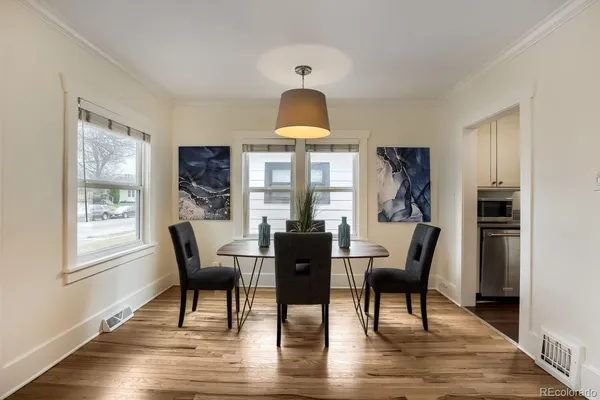 a dining room with furniture and wooden floor
