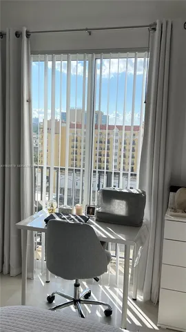 a view of a room with a large window and couch