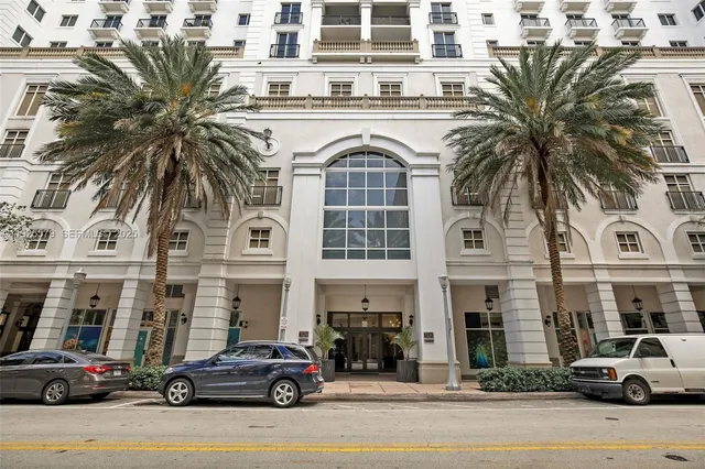 a city street lined with buildings and cars parked on the side of a road
