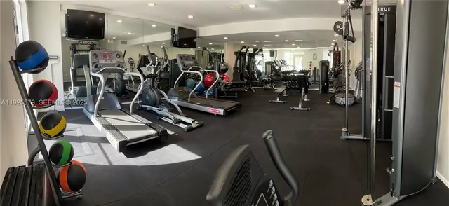 a living room with patio furniture and a flat screen tv