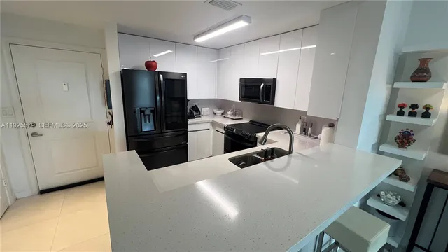 a kitchen with stainless steel appliances a refrigerator and a stove top oven