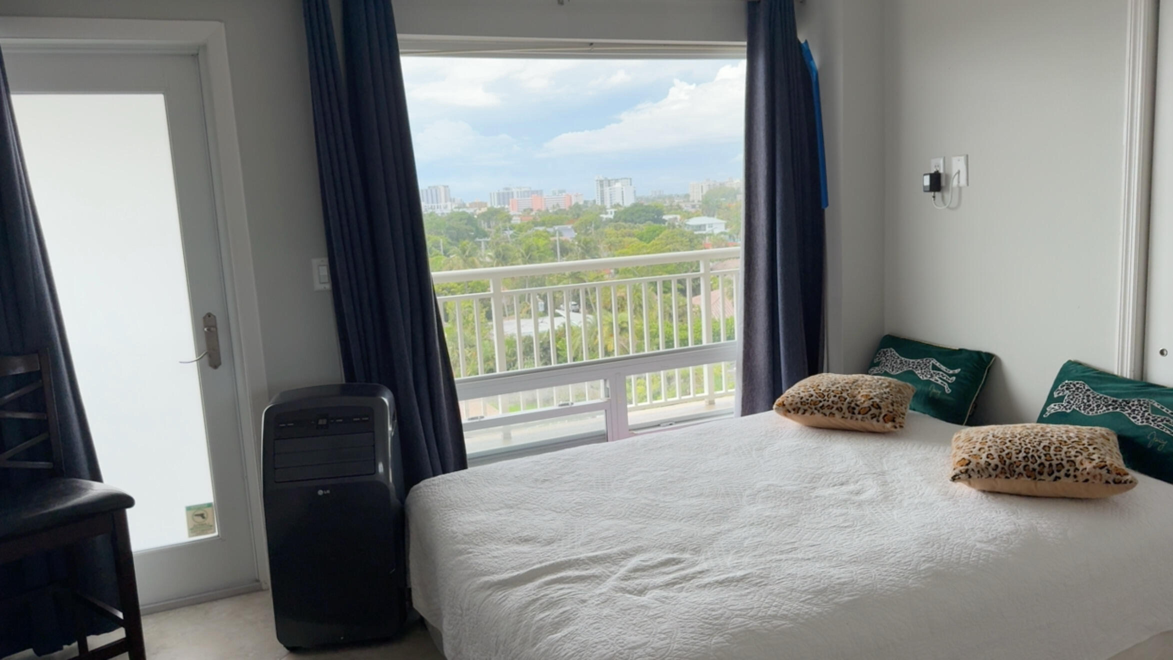 2611 North Riverside Drive, Unit 703 Pompano Beach, FL 33062 - Photo 80 of 81 a bed sitting in a bedroom next to a window