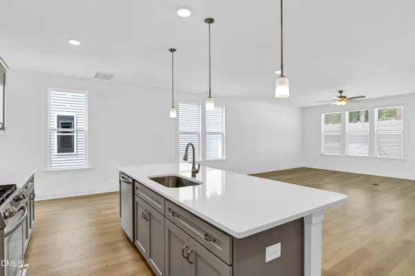 a kitchen with a sink a counter space and a window