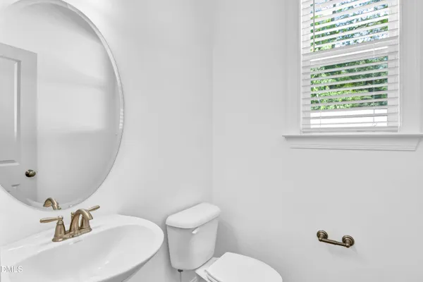 a bathroom with a sink mirror and toilet