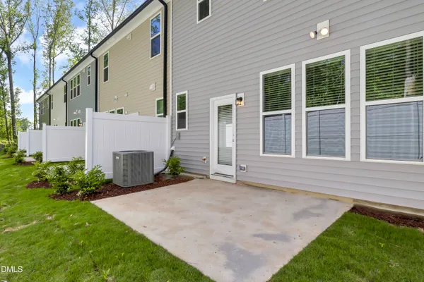 a view of an house with backyard and a garage