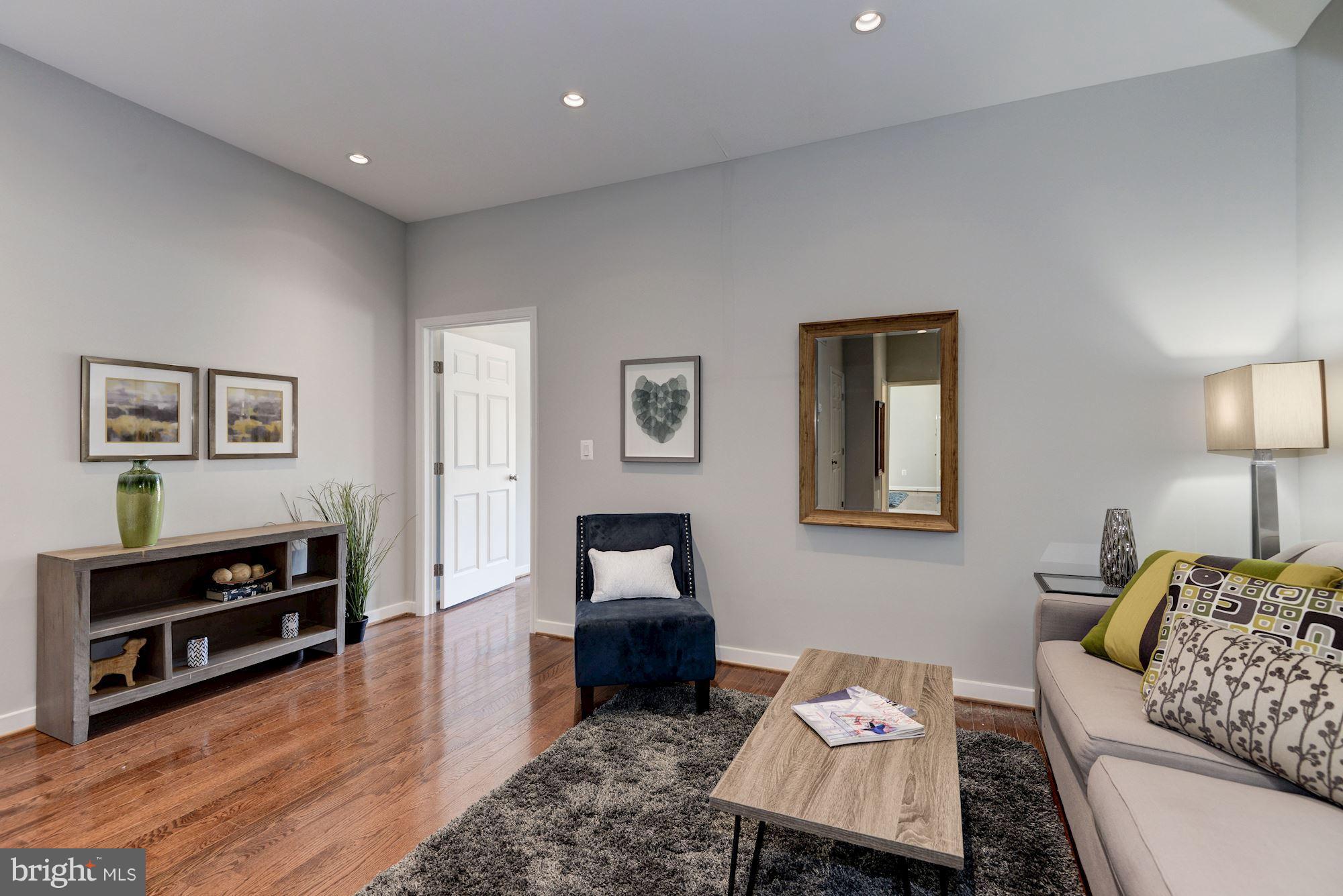 1616 6th Street Northwest, Unit 2 Washington, DC 20001 - Photo 11 of 20 a living room with furniture and wooden floor