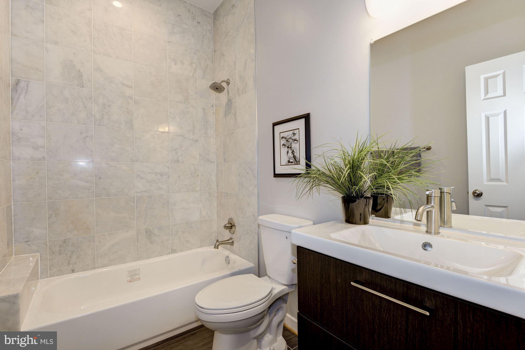 1616 6th Street Northwest, Unit 2 Washington, DC 20001 - Photo 15 of 20 a bathroom with a sink toilet and shower