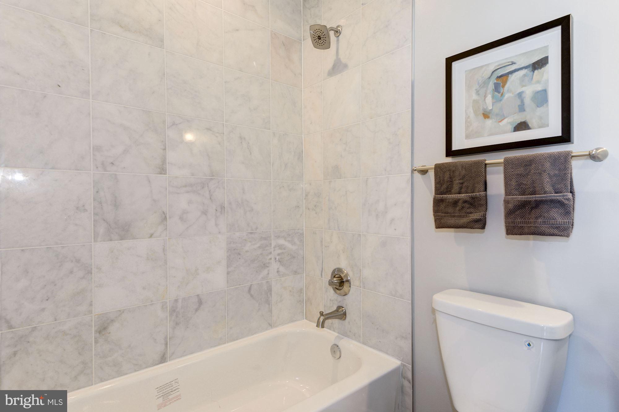 1616 6th Street Northwest, Unit 2 Washington, DC 20001 - Photo 16 of 20 a bathroom with a toilet a sink and mirror