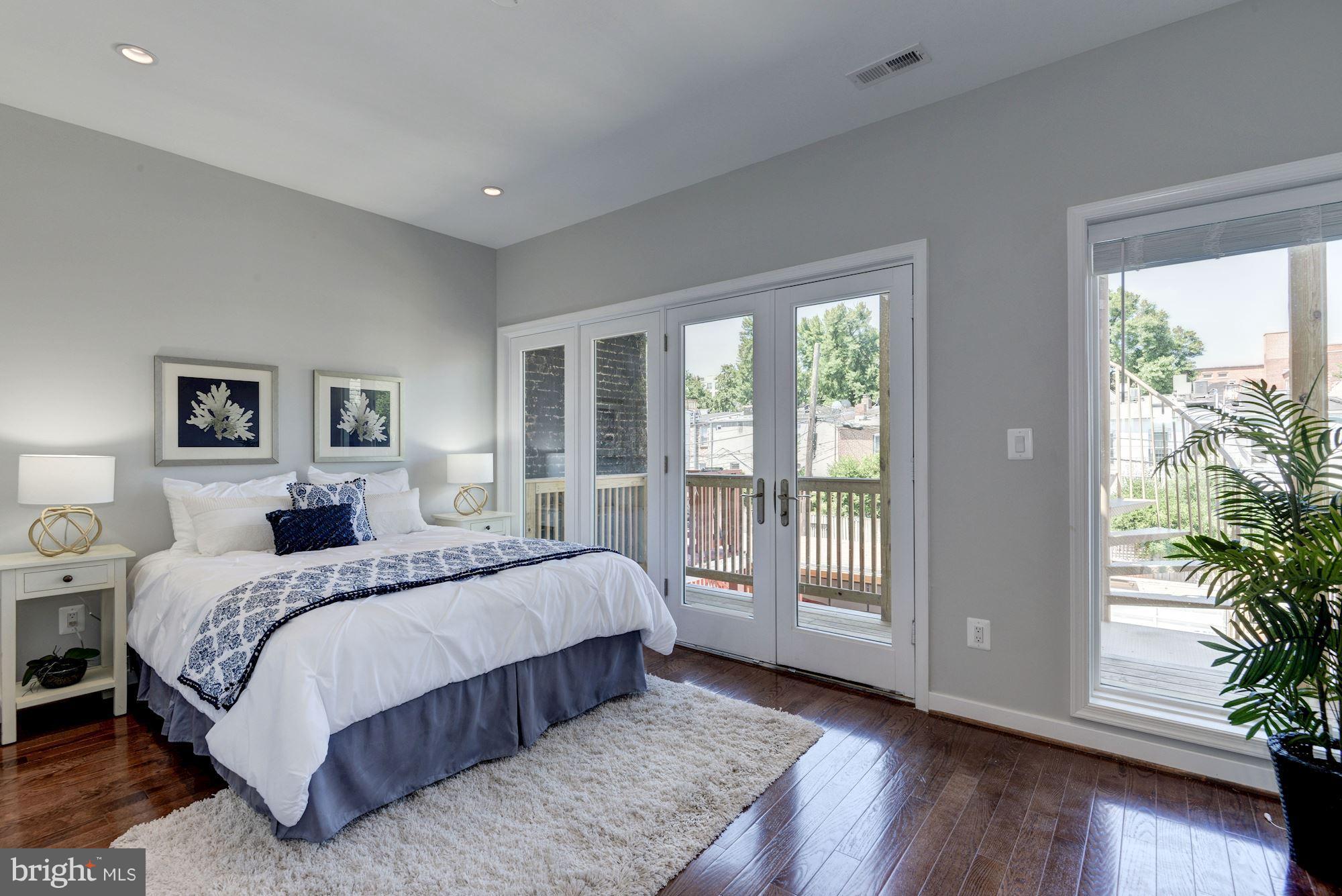 1616 6th Street Northwest, Unit 2 Washington, DC 20001 - Photo 6 of 20 a bedroom with a large bed and a large window