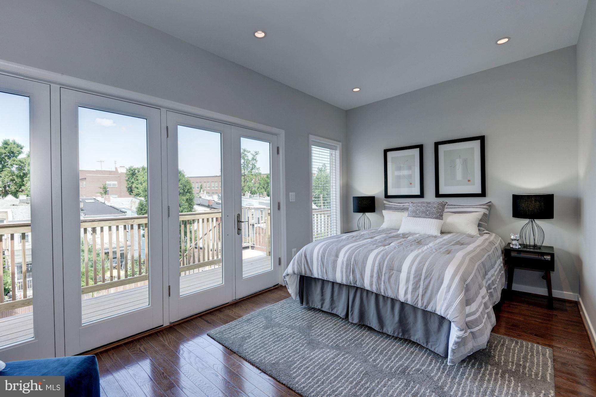 1616 6th Street Northwest, Unit 2 Washington, DC 20001 - Photo 7 of 20 a bedroom with a large bed and a large window