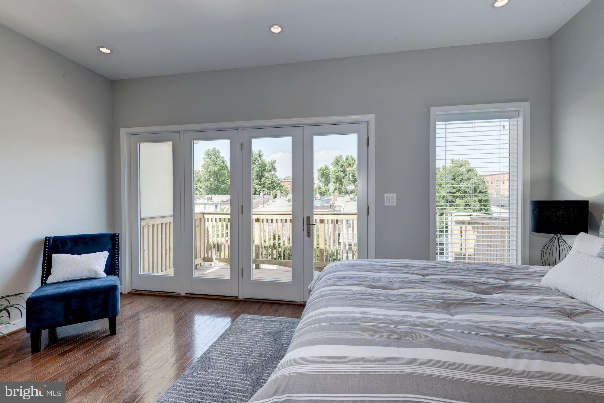 1616 6th Street Northwest, Unit 2 Washington, DC 20001 - Photo 8 of 20 a spacious bedroom with a bed and a couch with window