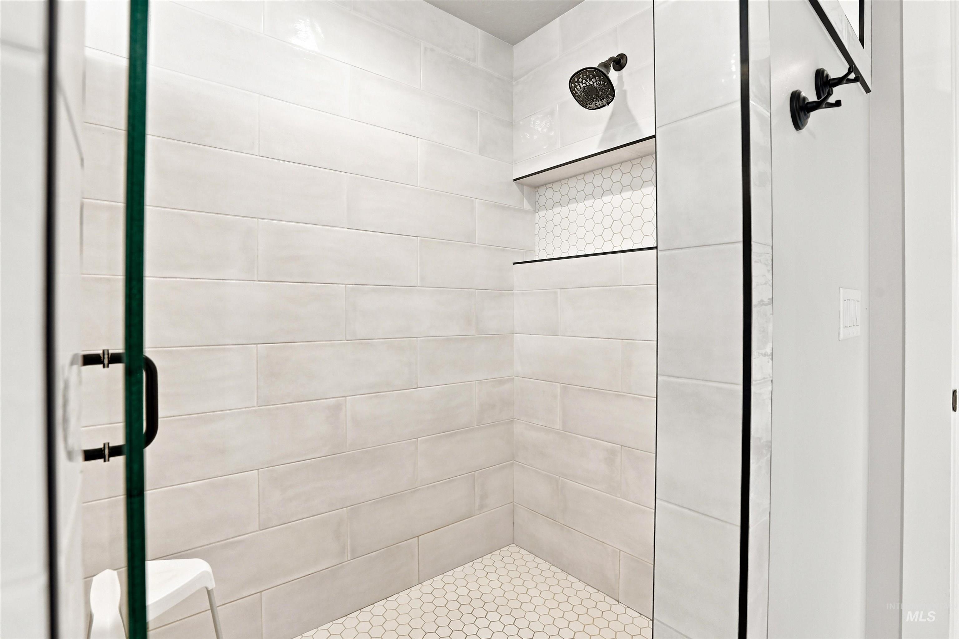4323 West Ladle Rpds Drive Meridian, ID 83646 - Photo 21 of 49 Glass-enclosed shower featuring large format tile walls and a hexagonal tile floor