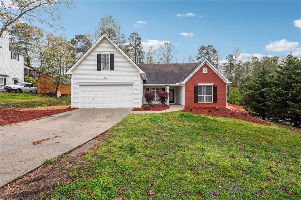 1200 Riverside Road Sugar Hill, GA 30518 - Photo 1 of 1 a front view of a house with yard