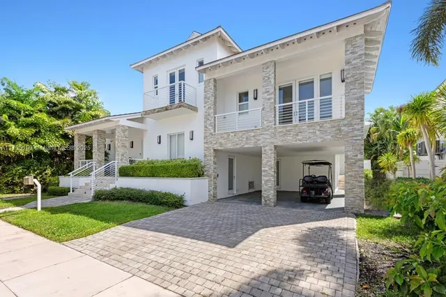 a view of a white house with a yard and plants