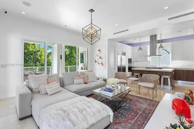 a living room with furniture wooden floor and a chandelier
