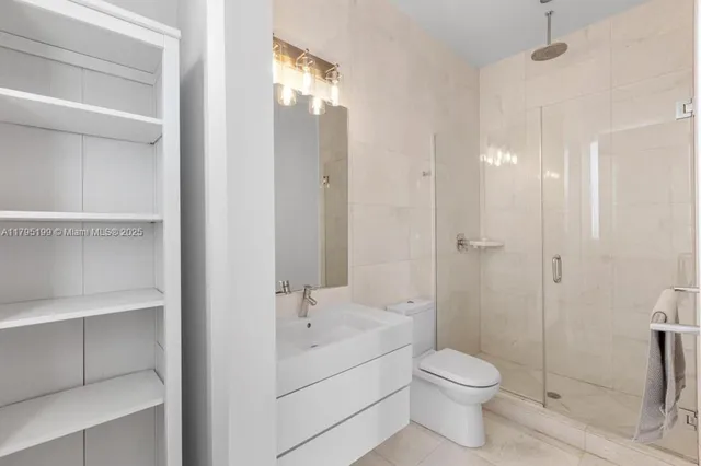 a bathroom with a toilet sink and shower