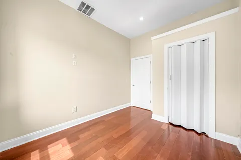 an empty room with wooden floor