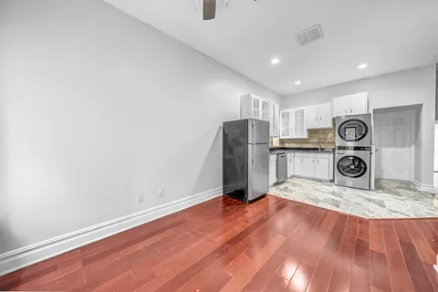 a view of kitchen with refrigerator microwave and stove