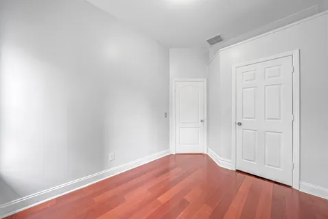 a view of an empty room and wooden floor