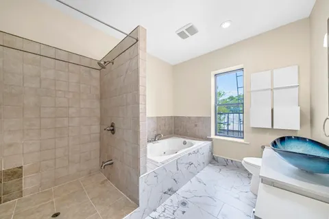 a bathroom with a tub sink and a shower