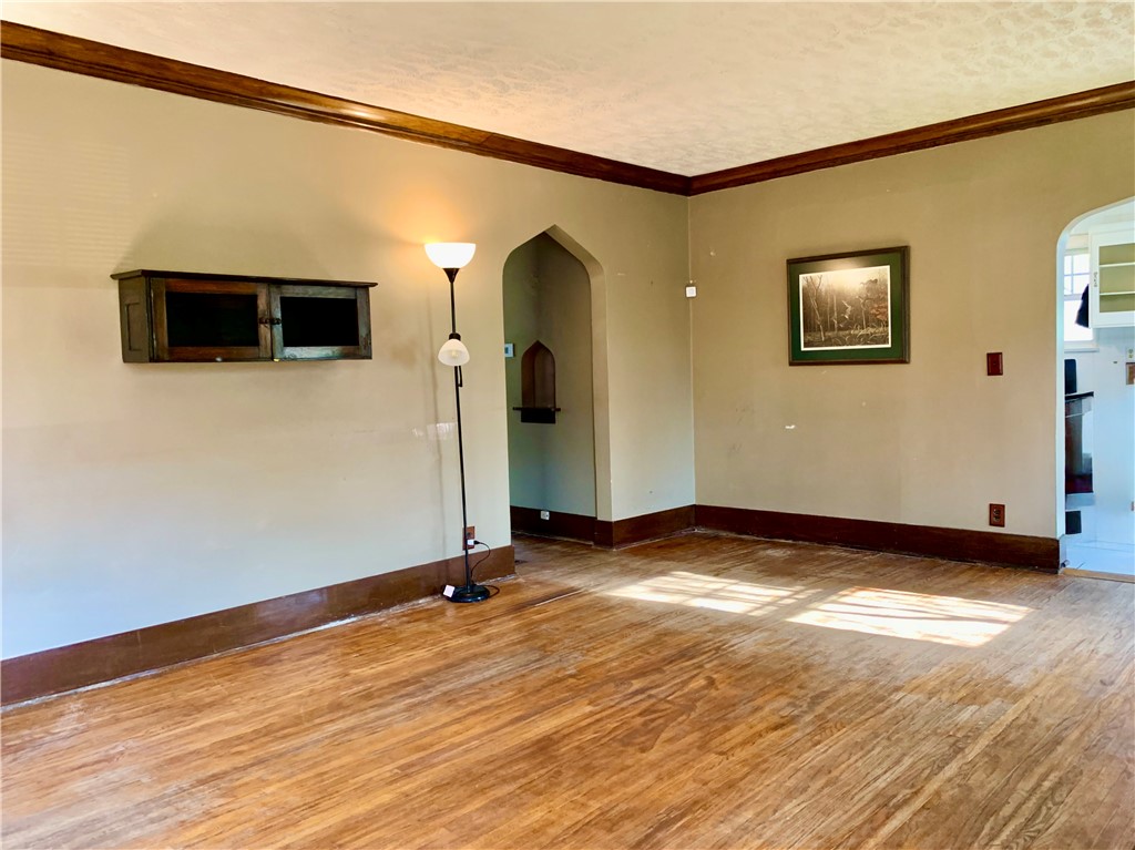 2301 East Wood Street Decatur, IL 62521 - Photo 5 of 17 a view of a livingroom with wooden floor and a flat screen tv
