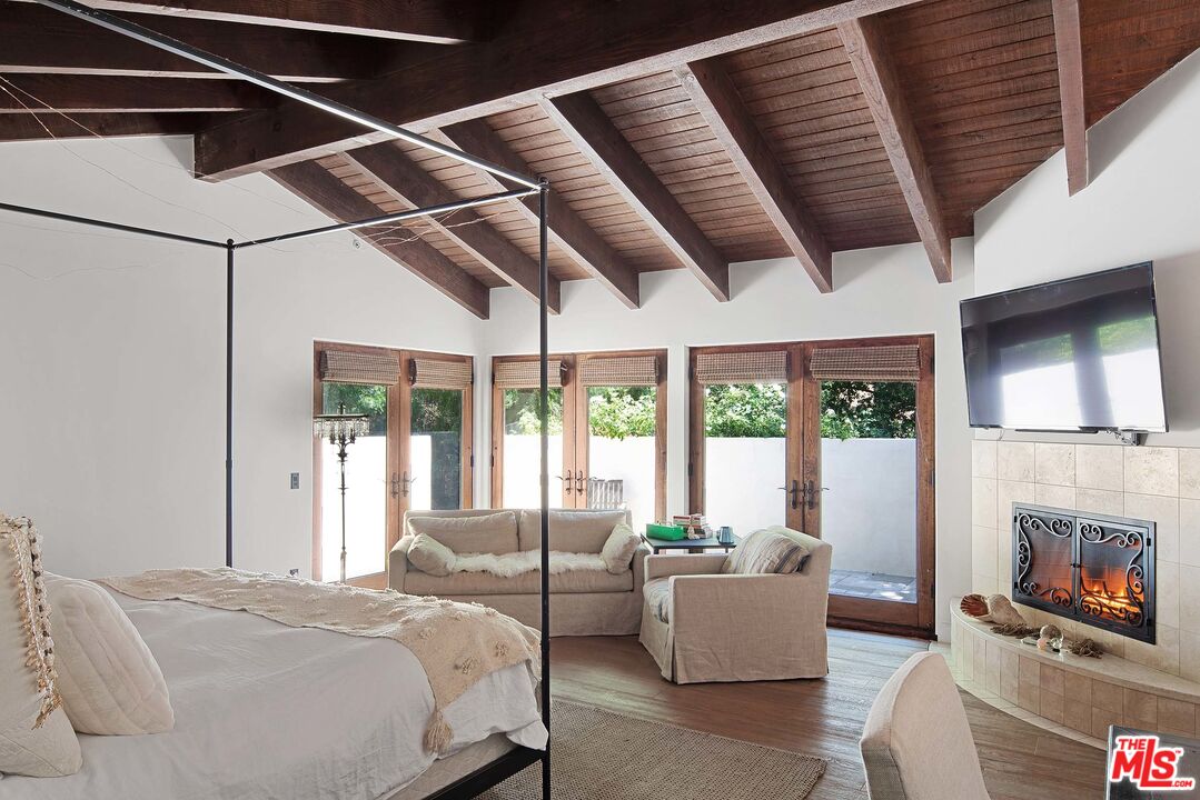 2251 Cold Canyon Road Calabasas, CA 91302 - Photo 17 of 47 a bedroom with furniture and a fireplace