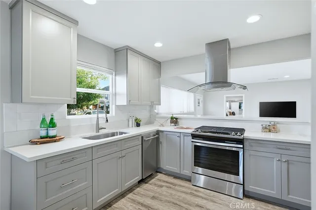 a kitchen with a sink stove and microwave