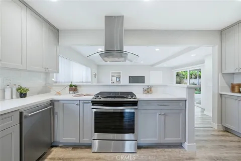 a kitchen with stainless steel appliances granite countertop a stove and a sink