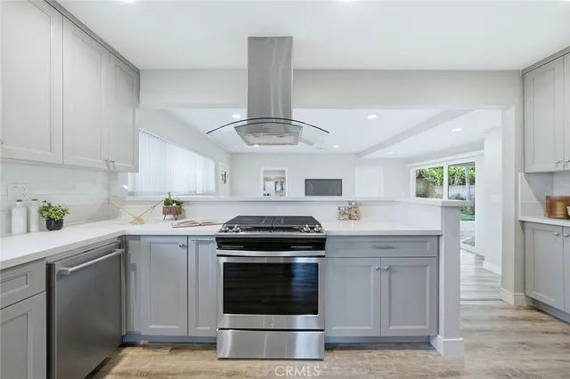 a kitchen with stainless steel appliances granite countertop a stove and a sink