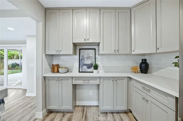 a kitchen with stainless steel appliances granite countertop a sink and cabinets with wooden floor