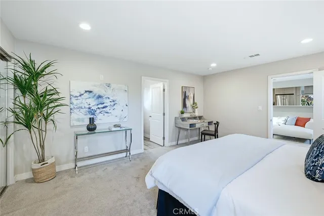 a bedroom with a large bed and a chandelier