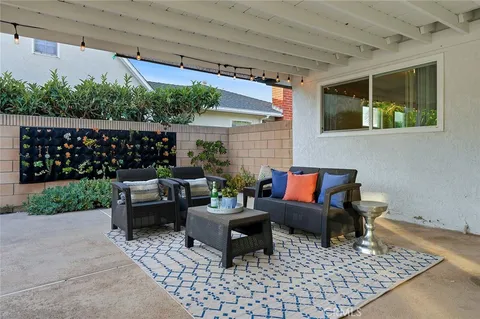 a building outdoor space with patio furniture and potted plants