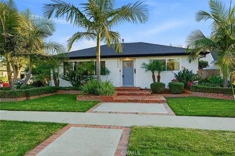 a front view of house with a garden