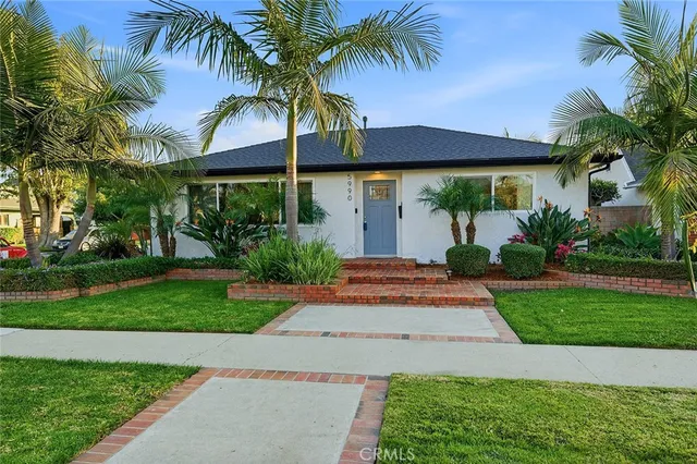 a front view of house with a garden