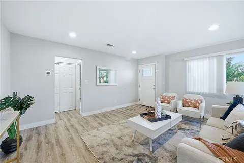 a living room with furniture and flowers