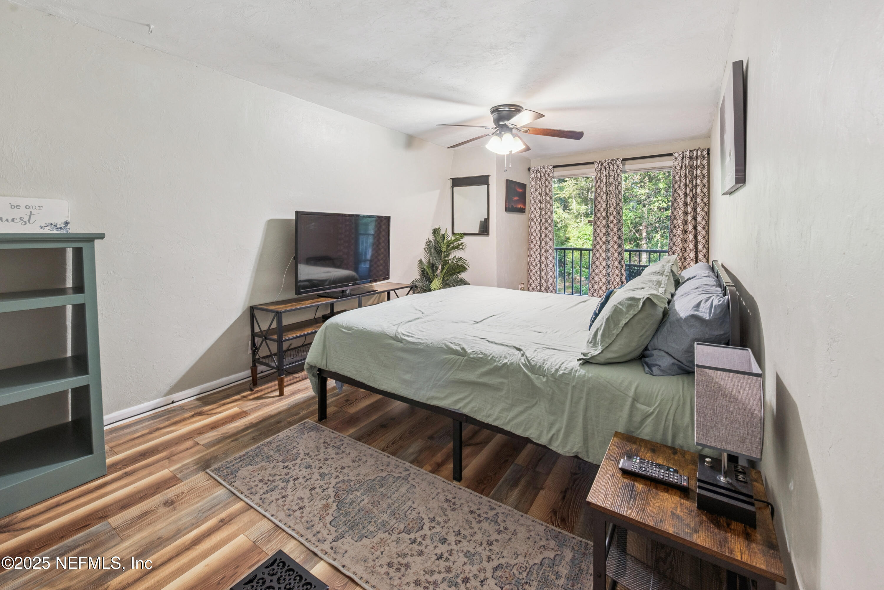 141 Southwest Longhorn Terrace Fort White, FL 32038 - Photo 16 of 31 a bedroom with a bed and wooden floor