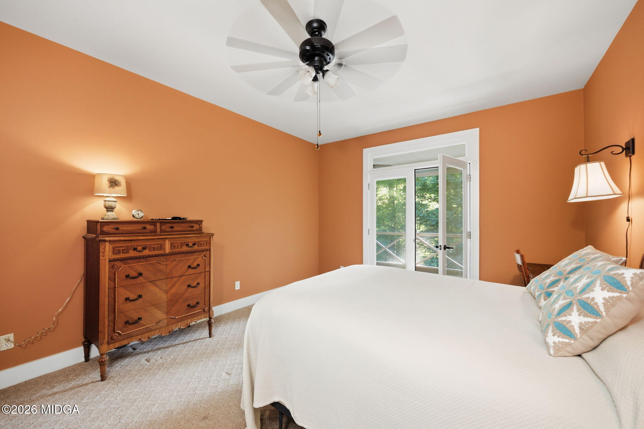 4686 Johnstonville Road Forsyth, GA 31029 - Photo 16 of 34 a bedroom with a bed and a chandelier