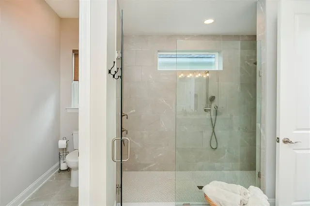 a living room with furniture and large windows