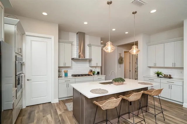 a work room with furniture a rug and a window