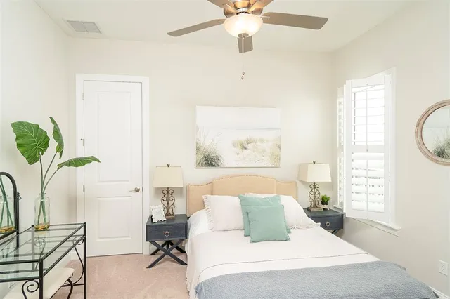 a living room with furniture and floor to ceiling windows