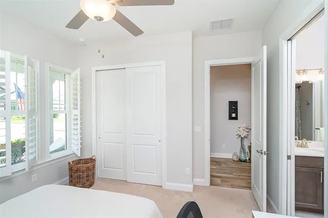 a living room with furniture a flat screen tv and a window
