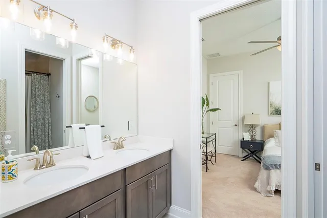 a view of a patio with table and chairs under an umbrella with palm trees