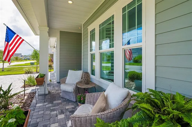 a spacious bedroom with a bed a flat screen tv and a large window