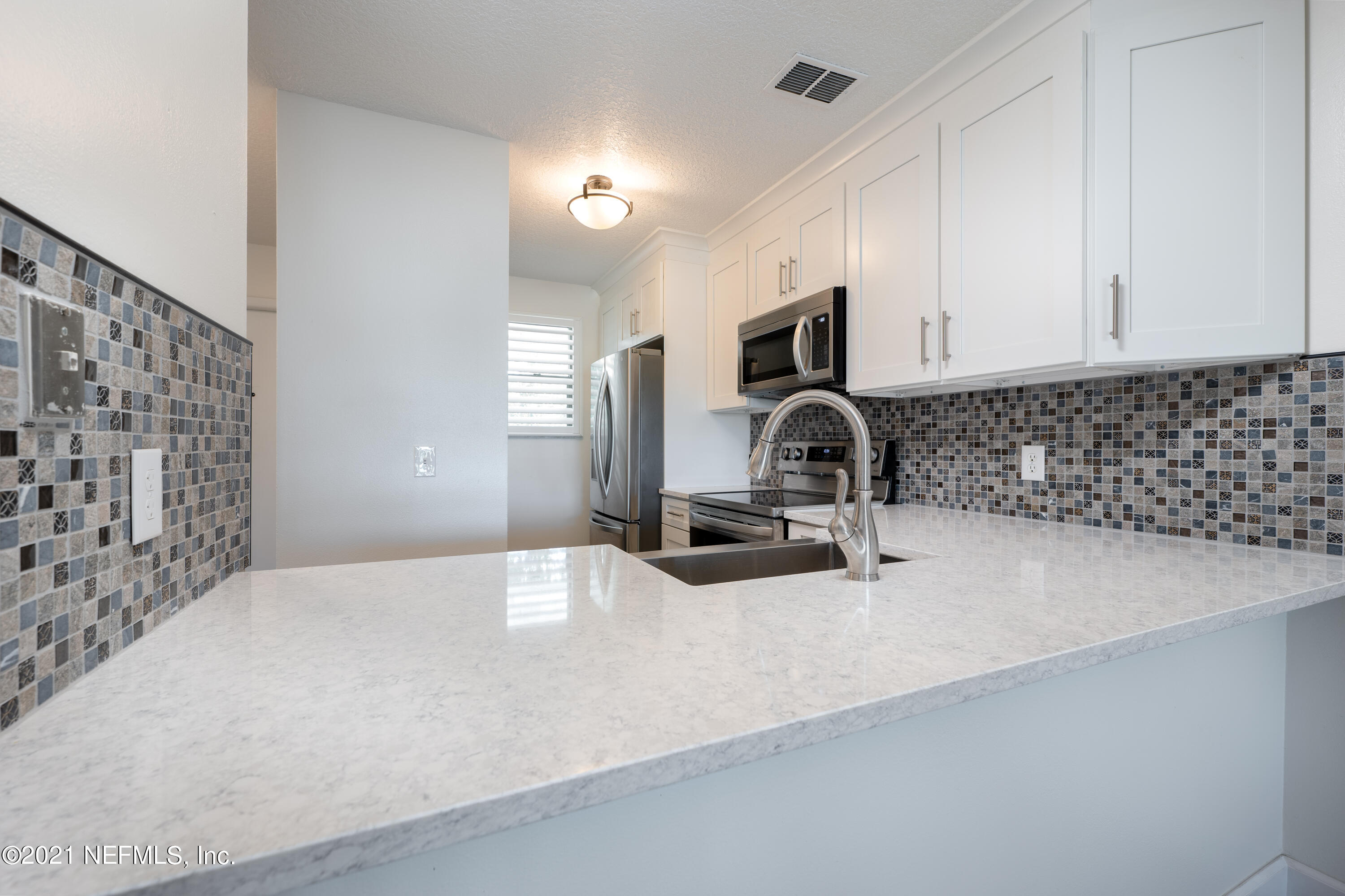 650 Pope Road, Unit 228 St. Augustine, FL 32080 - Photo 3 of 20 a bathroom with a sink and a mirror