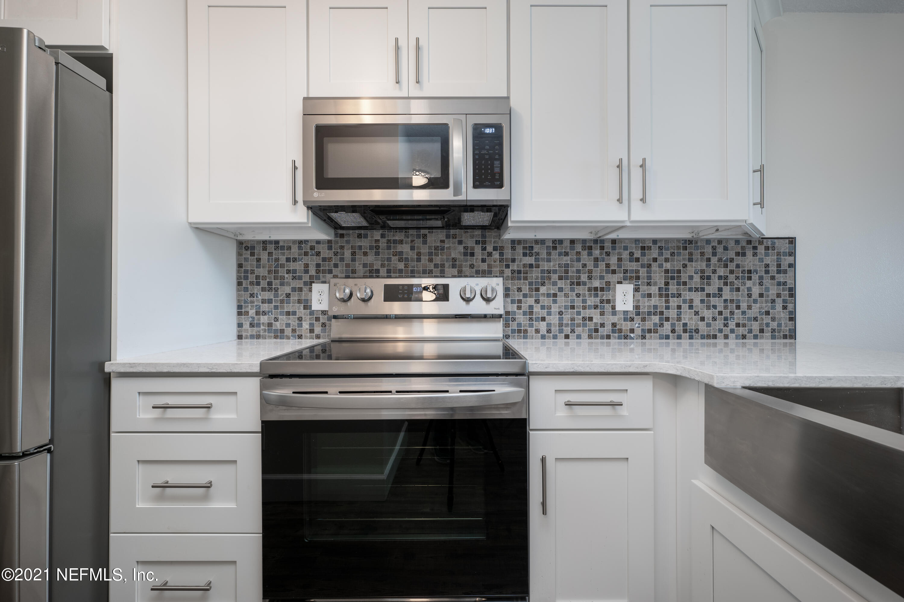 650 Pope Road, Unit 228 St. Augustine, FL 32080 - Photo 4 of 20 a kitchen with stainless steel appliances granite countertop a stove microwave and oven