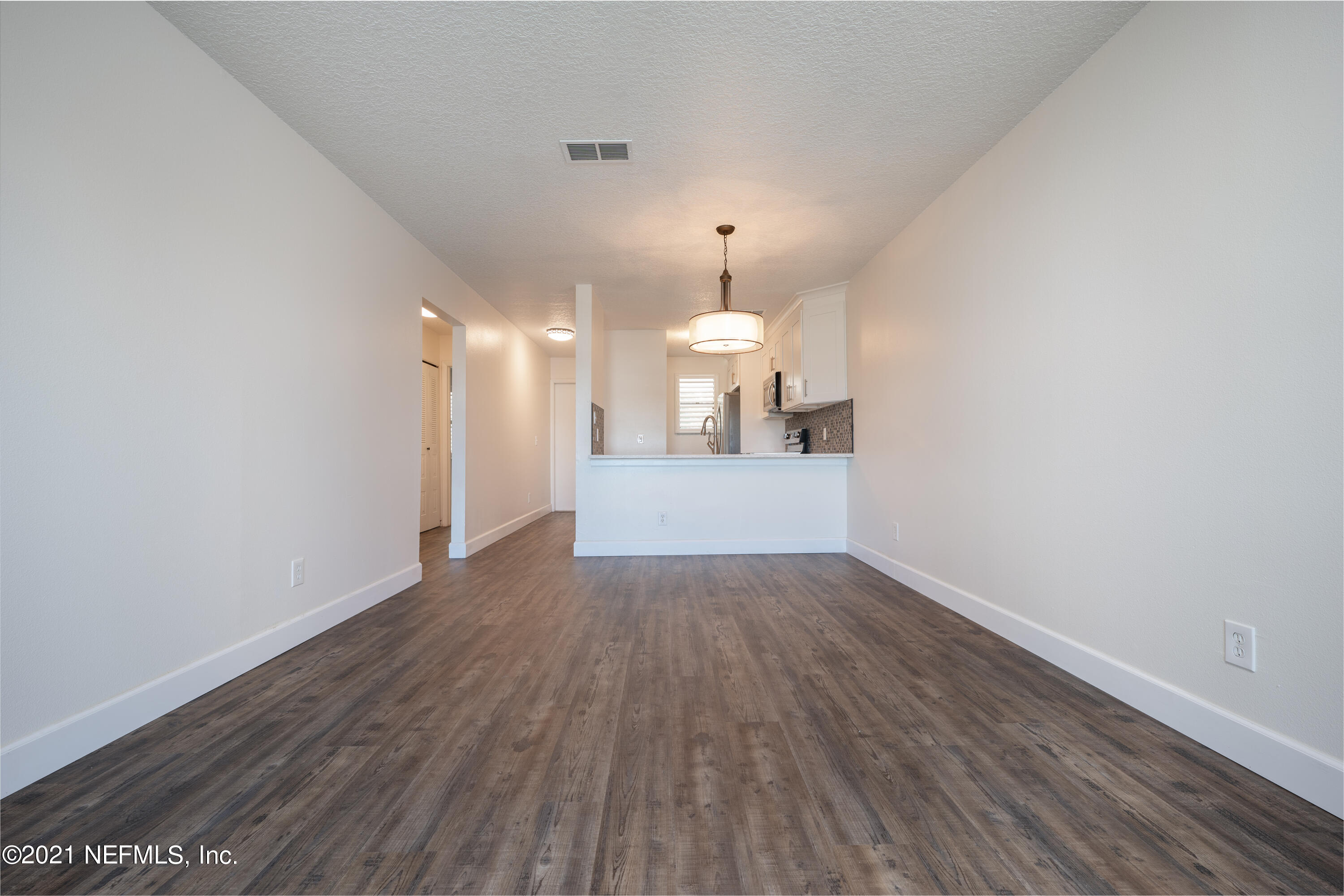 650 Pope Road, Unit 228 St. Augustine, FL 32080 - Photo 7 of 20 a view of a room with wooden floor and a window