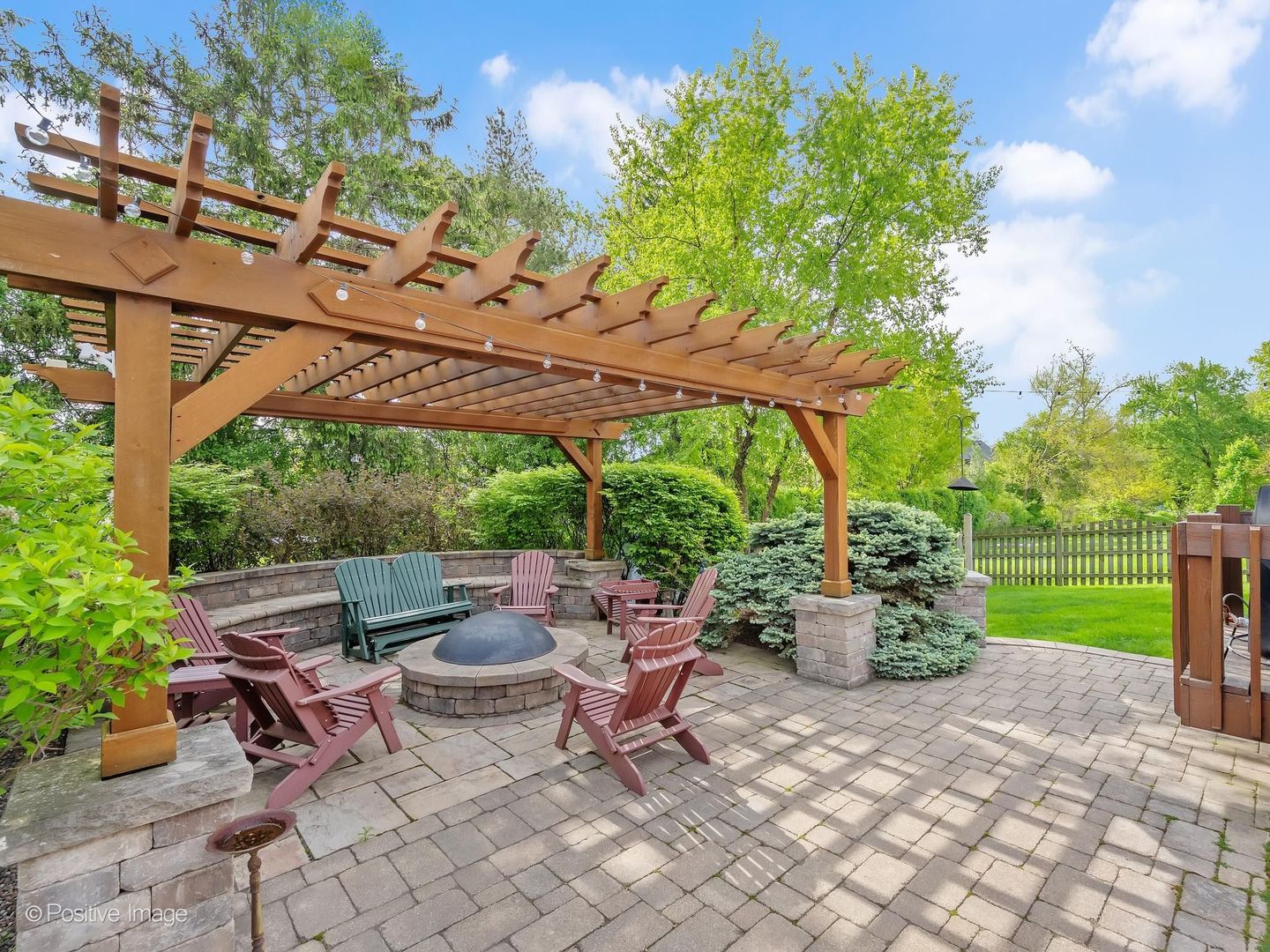6451 Garfield Ridge Court Burr Ridge, IL 60527 - Photo 25 of 28 a view of a patio with table and chairs potted plants and a large tree