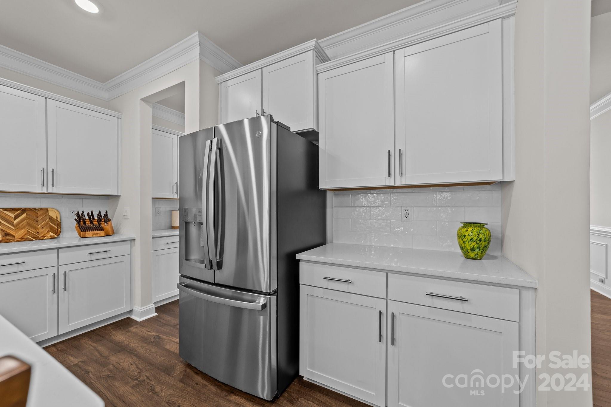 6037 Treehouse Drive Charlotte, NC 28214 - Photo 11 of 48 a kitchen with stainless steel appliances white cabinets and a refrigerator
