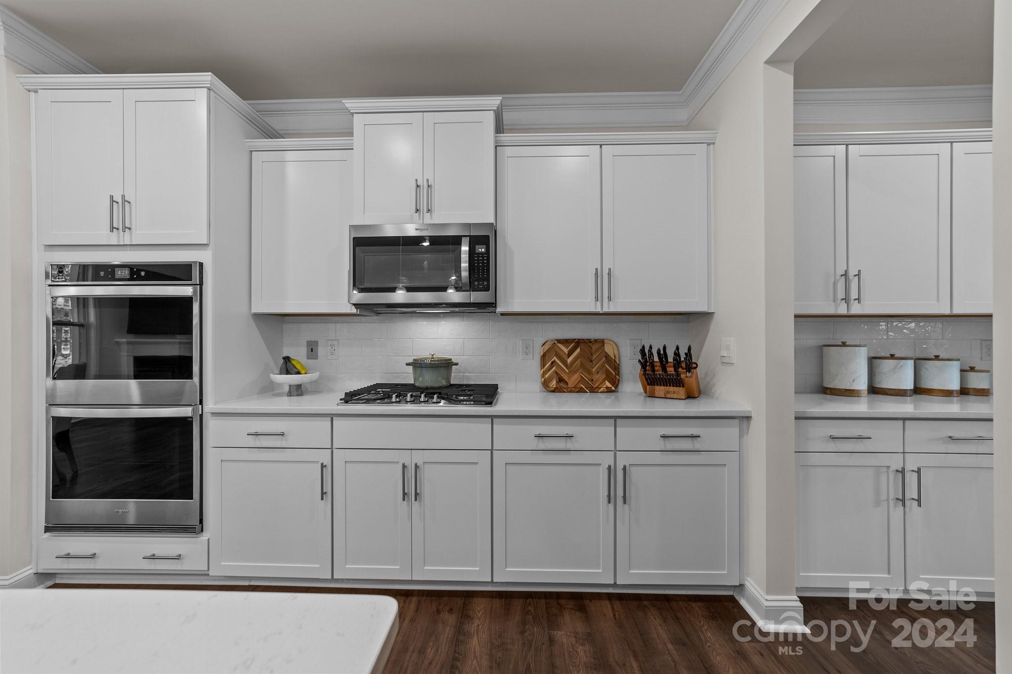 6037 Treehouse Drive Charlotte, NC 28214 - Photo 12 of 48 a kitchen with stainless steel appliances granite countertop a stove a sink and white cabinets